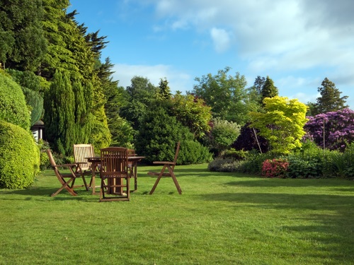 English garden in summer with furniture